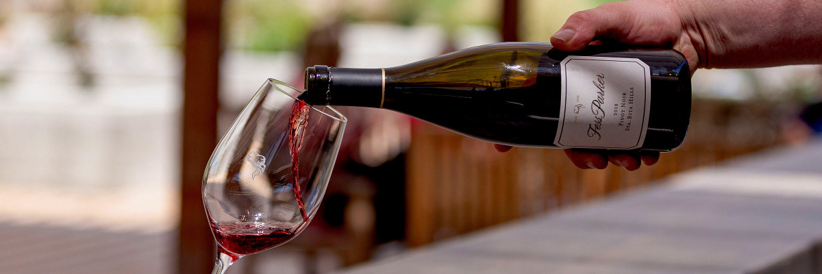 Fess Parker Pinot Noir being poured into a coonskin cap etched glass